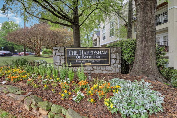 Front view of a residential building with a sign for The Habersham of Buckhead.