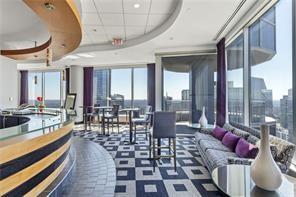 Interior view of a stylish club house with modern seating and large windows.