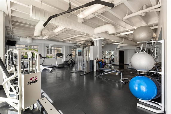 Interior view of a gym equipped with various exercise machines and fitness equipment.