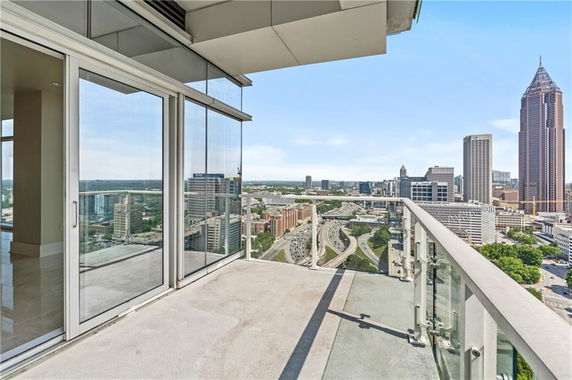 Panoramic view from a building's balcony showing a cityscape with several skyscrapers.