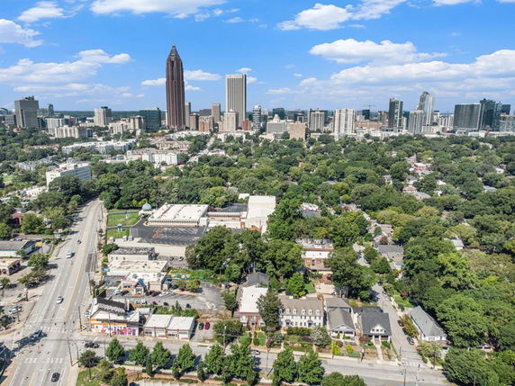 Aerial panoramic view of a cityscape with skyscrapers and residential areas.