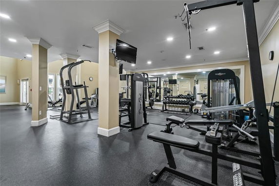 Indoor gym area with exercise equipment and mirrors.