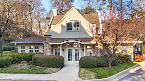 Front view of a house with stone accents and a gabled roof.