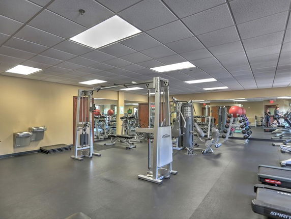 Interior view of a gym with various exercise equipment.
