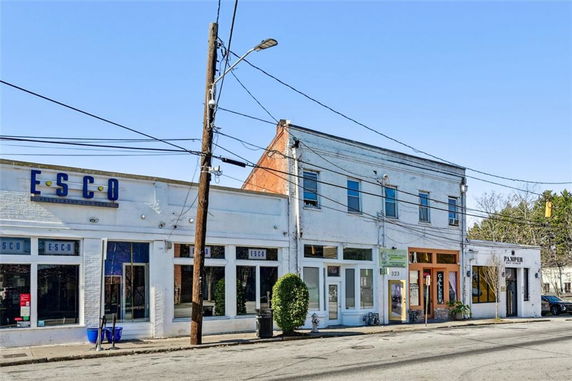 Front view of a two-story commercial building with multiple shopfronts.