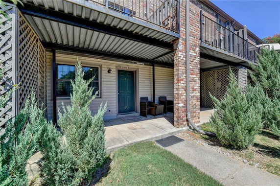 Front view of a building entrance with a patio area.