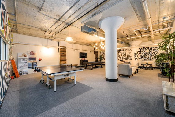 Indoor game room with a ping pong table and lounge area.