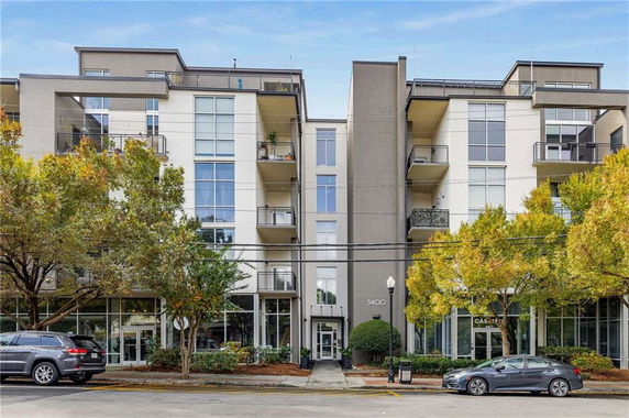 Front view of a modern multi-story apartment building with balconies.