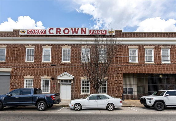 Front view of a two-story commercial brick building with multiple windows and a central entrance.
