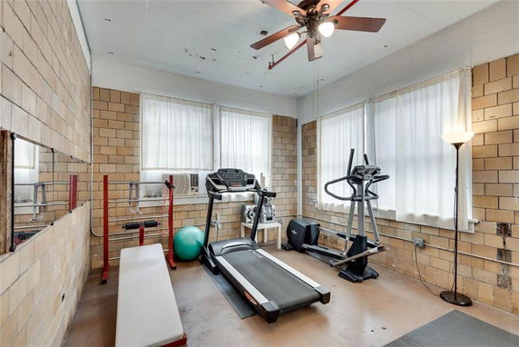 Indoor gym room with exercise equipment including a treadmill and elliptical machine.