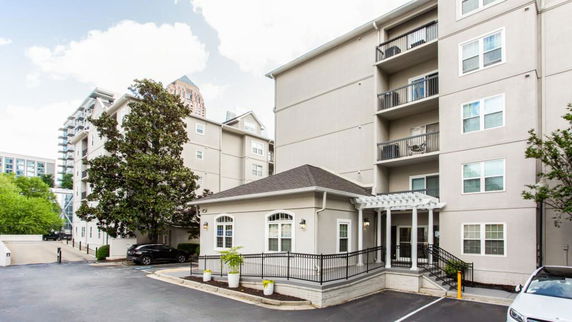 Front view of a multi-story residential building with balconies.