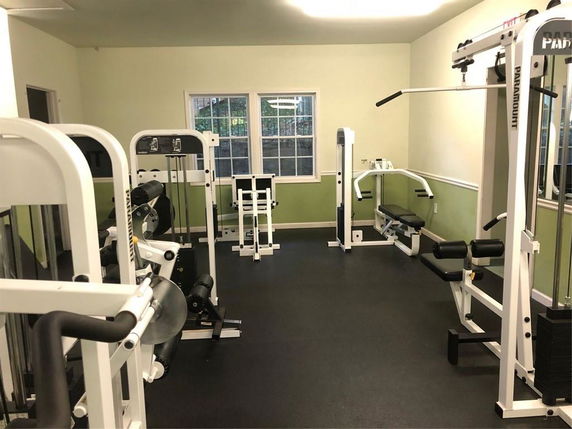 Indoor gym area with various fitness equipment.