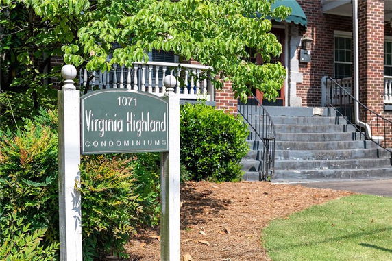 Front view of a condominium building with a sign reading '1071 Virginia Highland Condominiums.'