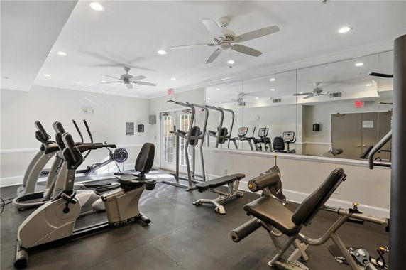 Interior view of a gym with exercise equipment and mirrors.