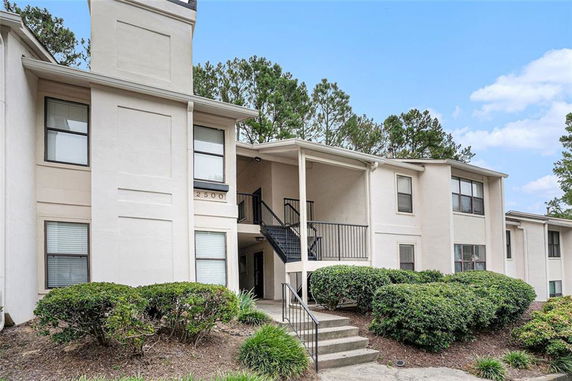 Front view of a multi-story residential building with exterior stairs.