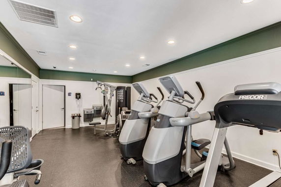 Indoor gym area with exercise machines and equipment.