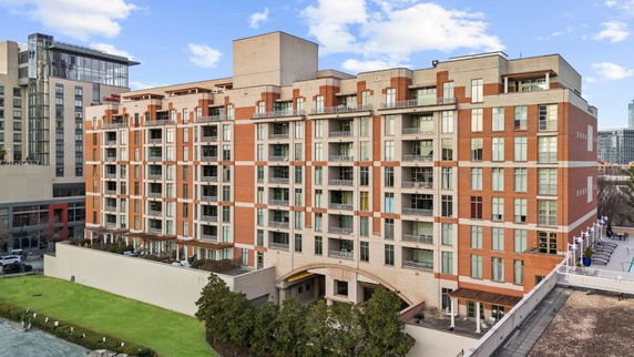Front view of a multi-story apartment building with a modern design.