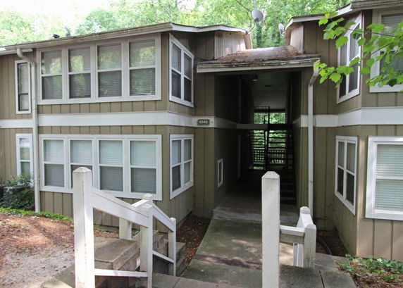 Front view of a multi-story residential building with a central entrance.