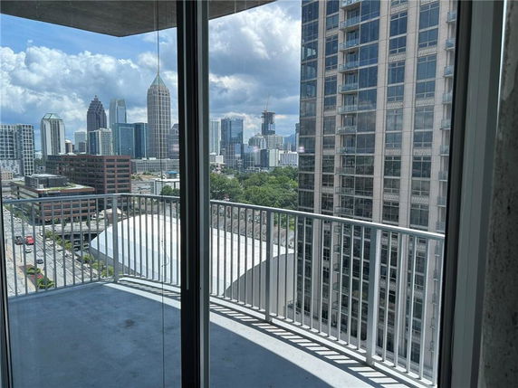 Panoramic view of city skyline seen from a balcony.