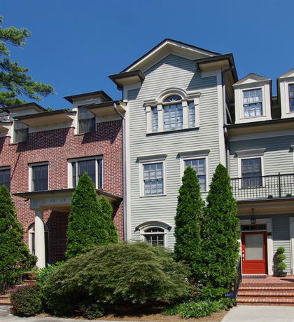 Front view of a townhouse with brick and siding exterior.
