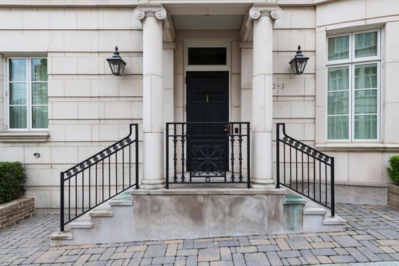 Front view of a house with columns and a black door
