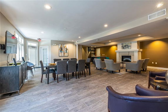 Interior view of a club house with seating and a fireplace.