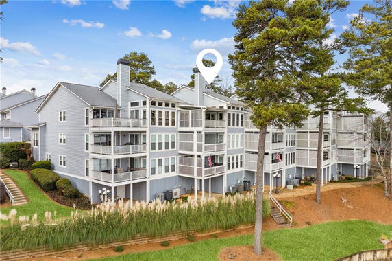 Front view of a multi-story building with balconies and large windows.