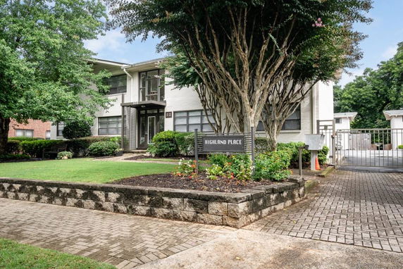 Front view of a two-story building with the sign 'Highland Place'.
