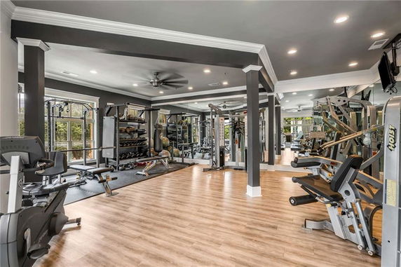 Indoor gym area with various fitness equipment and machines.
