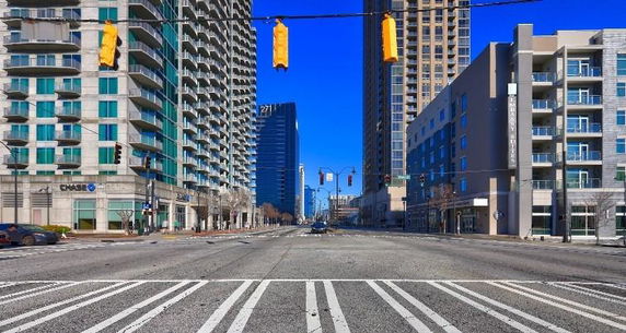 Front view of various multi-story buildings along a city street.