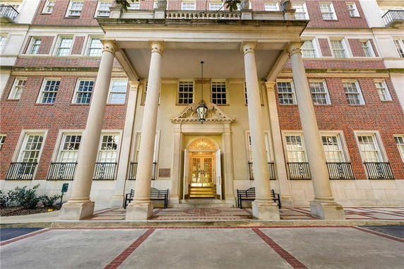 Front view of a multi-story building with large columns at the entrance.