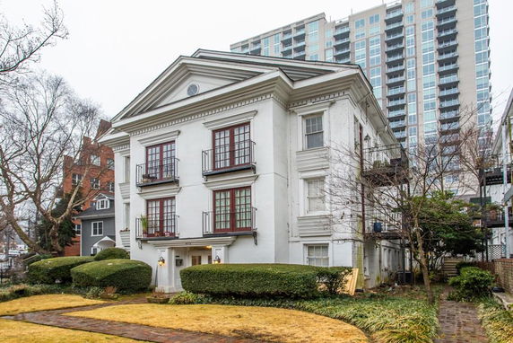 Front view of a multi-story building with a classical facade and balconies.