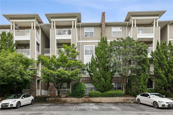 Front view of a multi-story residential building with balconies.