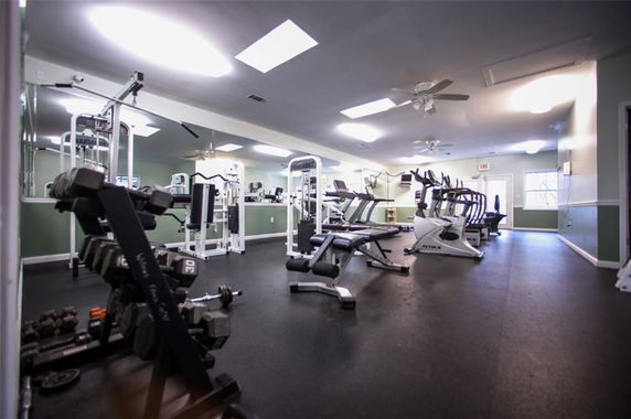 Interior view of a gym with various exercise equipment.