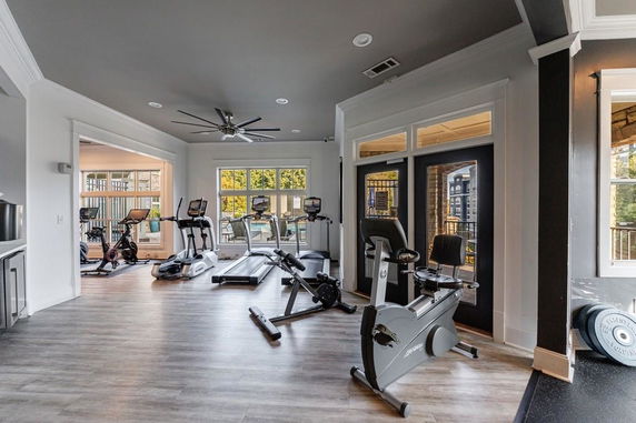 Indoor gym area with exercise equipment including treadmills and stationary bikes.