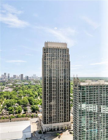 Front view of a tall skyscraper building in an urban area.