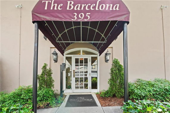 Front view of a building entrance with an awning that says 'The Barcelona 395'.