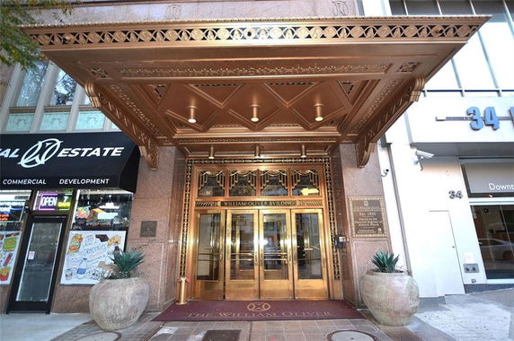 Front entrance of a building with ornate details and a canopy.