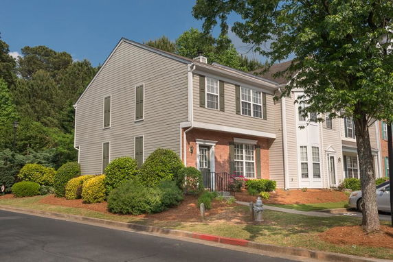 Front view of a two-story house with brick and siding exterior.