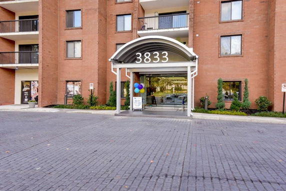 Front view of a brick building with a canopy entrance.
