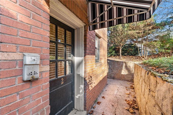 Entrance view of a building with a brick exterior and door number 2.
