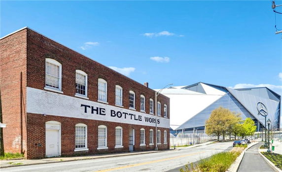 Front view of a two-story brick building labeled 'The Bottle Works.'