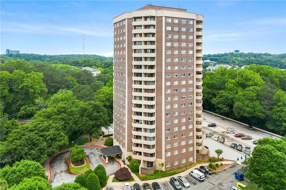 Front view of a tall residential building with multiple floors.