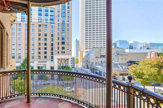 View from a balcony showing a cityscape with high-rise buildings.