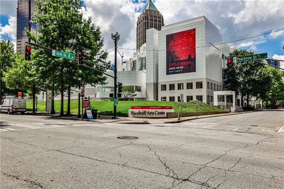 Front view of a modern multi-story art center building at a street corner.