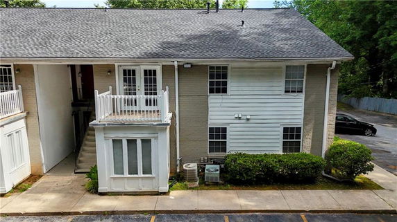 Front view of a two-story residential building with a small balcony.