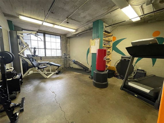 Indoor gym area with exercise equipment and fitness machines.