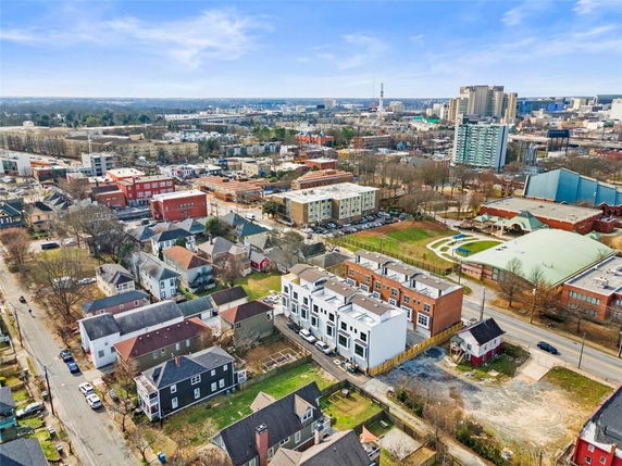 Aerial view of a city with residential houses, apartment buildings, and a park area.