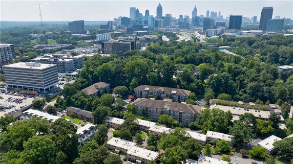 Wide-angle view of a cityscape with multiple buildings and greenery.