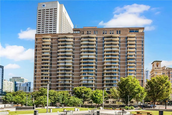 Front view of a high-rise building with multiple balconies.
